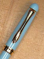 Designer twist, 24k-Gold with Roller-clip, Baby Blue acrylic