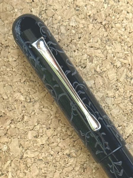 Loa Jr with Clip in Black Acrylic with Flower Scroll Engraving (cap close-up)